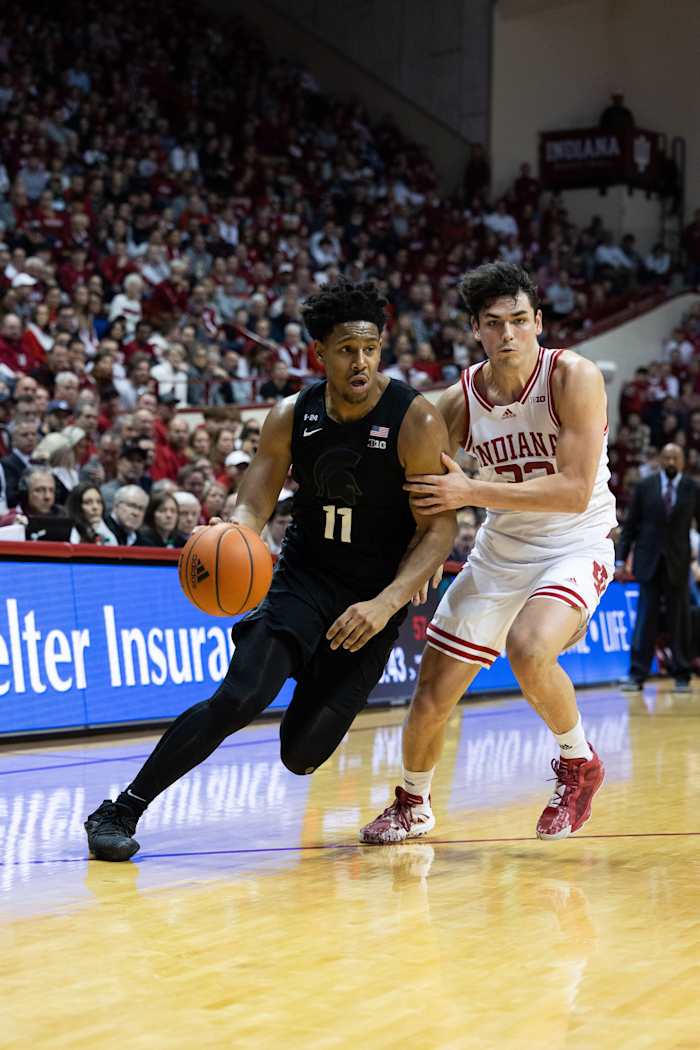 Michigan State Spartans guard A.J. Hoggard (11) dribbles the ball while Indiana Hoosiers guard Trey Galloway (32) defends in the second half at Simon Skjodt Assembly Hall.